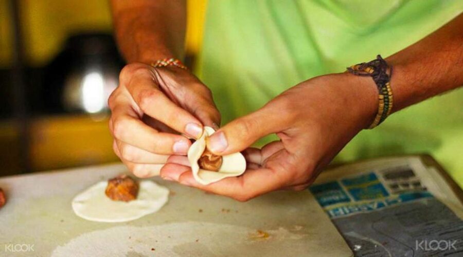 Kathmandu: Nepali Cooking Class with Hotel Pickup - Preparing momos, curries, roti, and sel roti